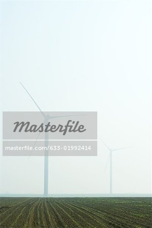 Wind turbines in foggy landscape