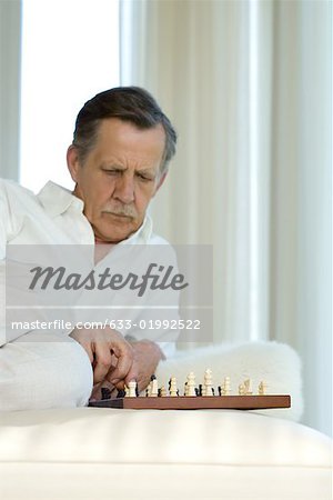 Man studying chessboard