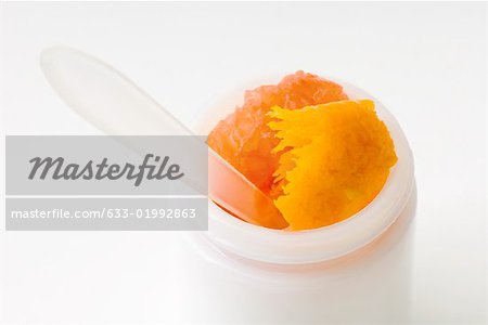 Citrus fruit inside of small cosmetics container, close-up