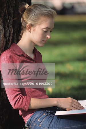 Girl Reading Under Tree
