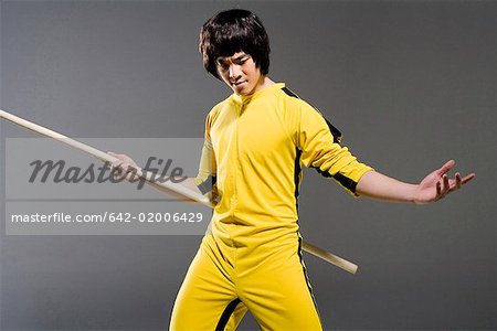 a man practicing a Chinese stick