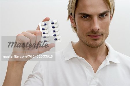 Portrait of Man Holding Pillen