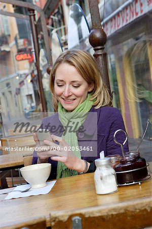 Woman Using Cell Phone in Cafe