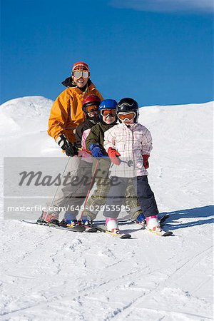 Mother skiing with children