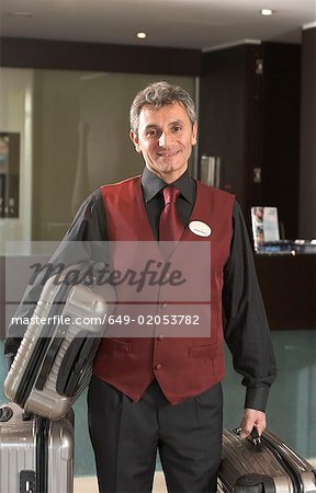 Portrait Hotel porter holding luggage