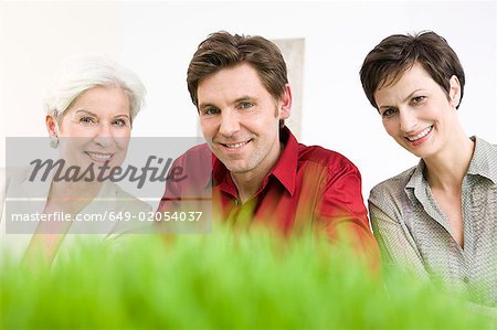 Mann und zwei Frauen vor Gras