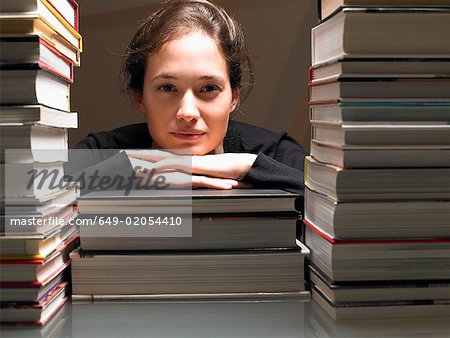 Woman resting on books