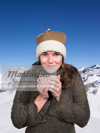 Young woman having drink at mountains
