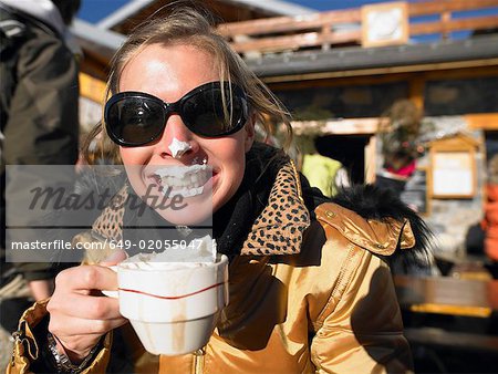 Young woman with whipped cream on lips