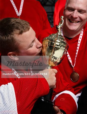 Hockey Player Kissing Trophy