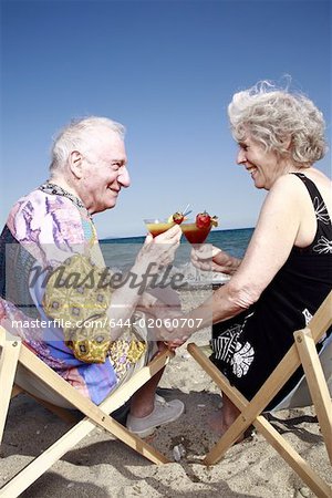 Couple Senior avec des cocktails sur la plage