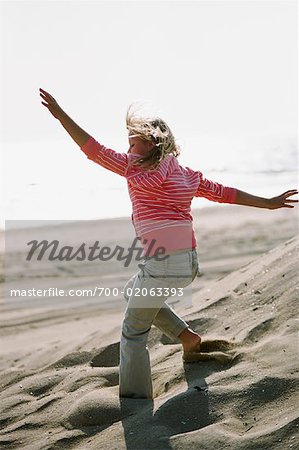 Girl Doing Cartwheel, Huntington Beach, California, USA
