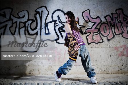 Female Hip Hop Dancer in Front of Wall of Graffiti