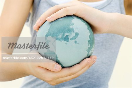 Child holding globe in hands, close-up