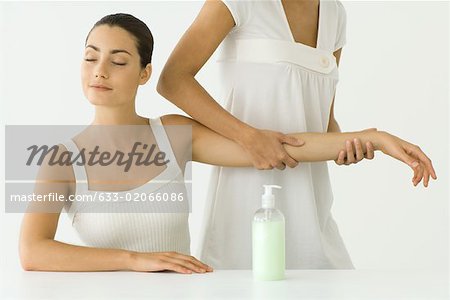 Woman receiving arm massage, eyes closed