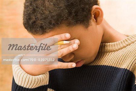 Boy Holding Pencil with Hand Over Face