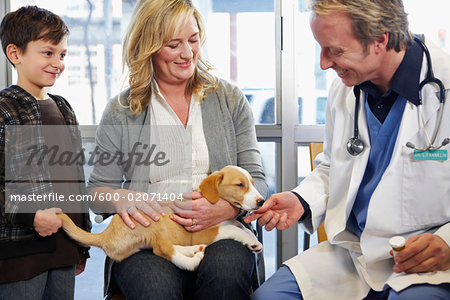 Boy and Woman with Dog at Veterinarian's Office