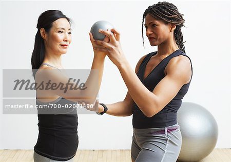 Woman Exercising with Personal Trainer