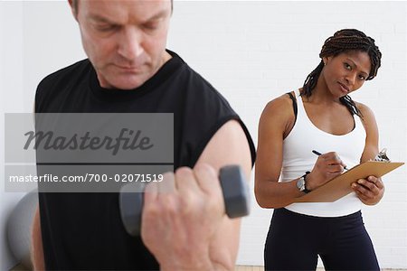 Man Exercising with Personal Trainer