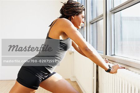 Woman Stretching in Fitness Studio