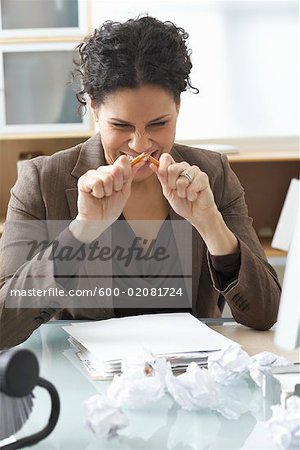 Businesswoman Sitting at Desk Writing