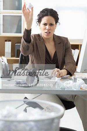 Businesswoman Sitting at Desk Writing