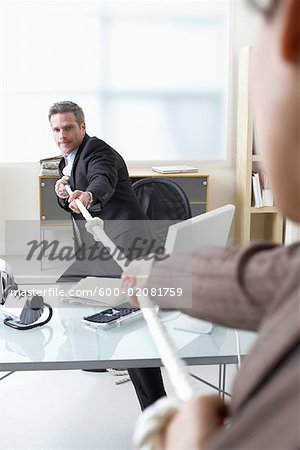 Business People in Tug-of-War at Desk