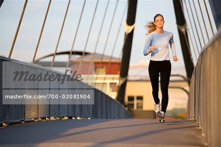 Woman Jogging on City Bridge, Portland, Oregon, USA