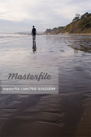 Man Walking on Arroyo Burro Beach Santa Barbara, California, USA