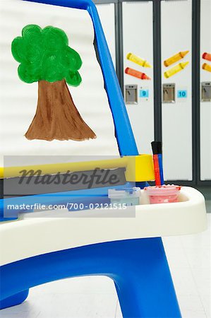 Child's Painting of Tree on Easel in Front of School Lockers