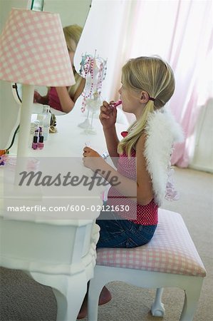 Little Girl Putting On Lipstick
