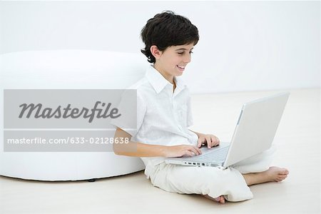 Boy sitting cross-legged on the floor using laZSop
