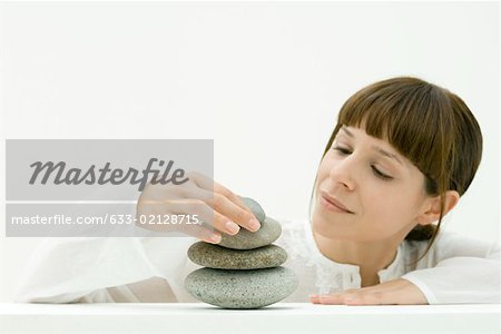 Woman stacking stones