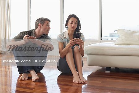 Couple with Cellular Phones in Condominium