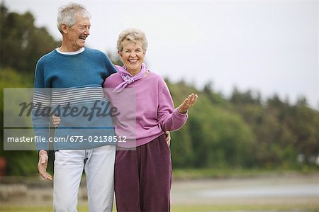 Senior couple laughing at the beach.