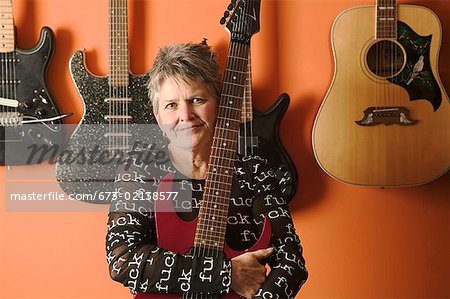 Portrait of a woman and her guitars.