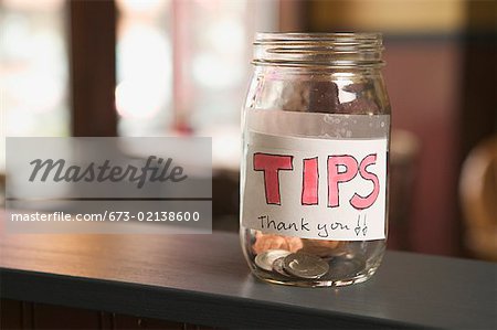 Still life of a nearly empty tip jar.