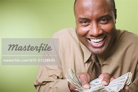 Man offering a fan of money.