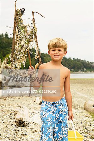 Boy holding up dried seaweed