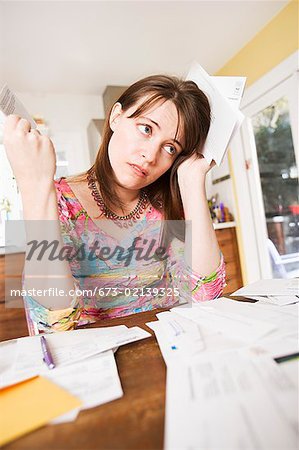 Woman sorting through bills at home