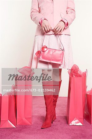 Woman standing with shopping bags