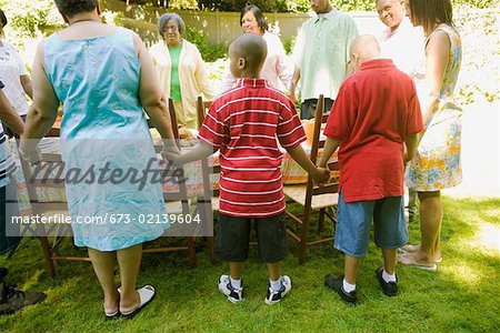 Family holding hands at picnic
