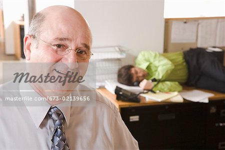 Portrait of boss with sleeping employee