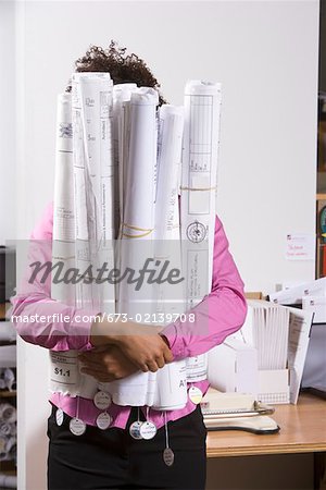 Woman holding bundle of blueprints