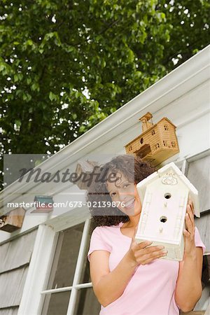 Woman with birdhouse collection