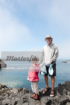 Father and daughter enjoying seaside stroll