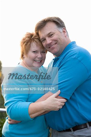 Portrait of middle aged couple hugging