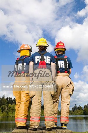 Three female firefighters viewed from behind