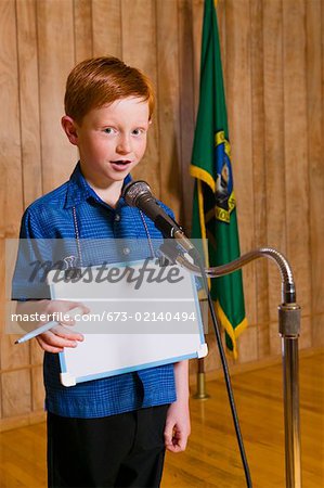 Young boy speaking at microphone