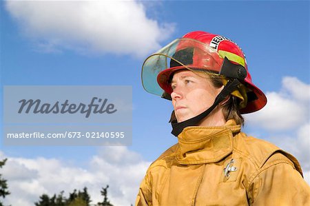 Female firefighter in uniform outside